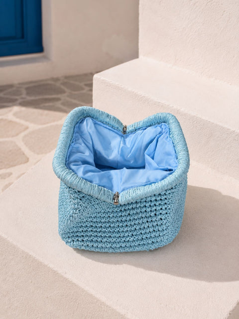 A light blue crocheted clutch raffia bag with a matching blue satin-lined interior.