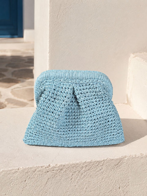 A light blue crocheted raffia clutch bag with a pleated front