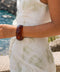 Modern wide acrylic bangle in translucent amber brown with geometric facets