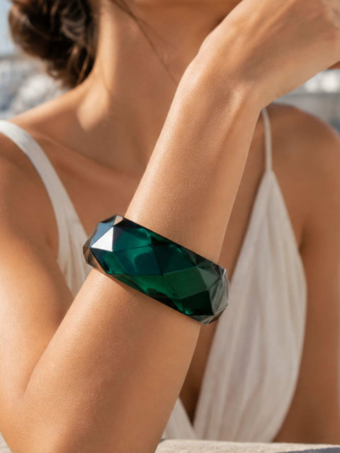 Front view of the Mavi green faceted acrylic bangle with a polished finish