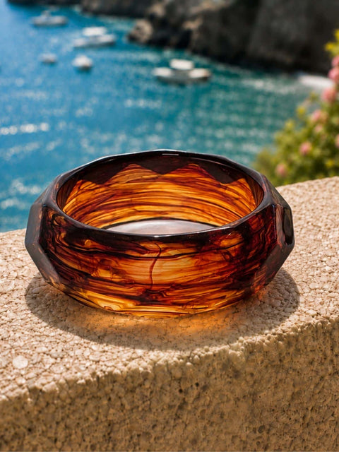 Front view of the Mavi honey brown acrylic bangle with bold faceted detailing