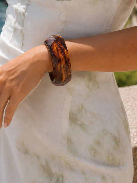Mavi honey brown faceted acrylic bangle with a glossy translucent finish