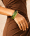 Green marbled resin bangle with rich brown swirls and a glossy finish