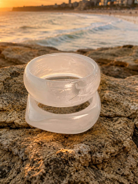 Two wide white marble acrylic bangles  stacked on top of each other