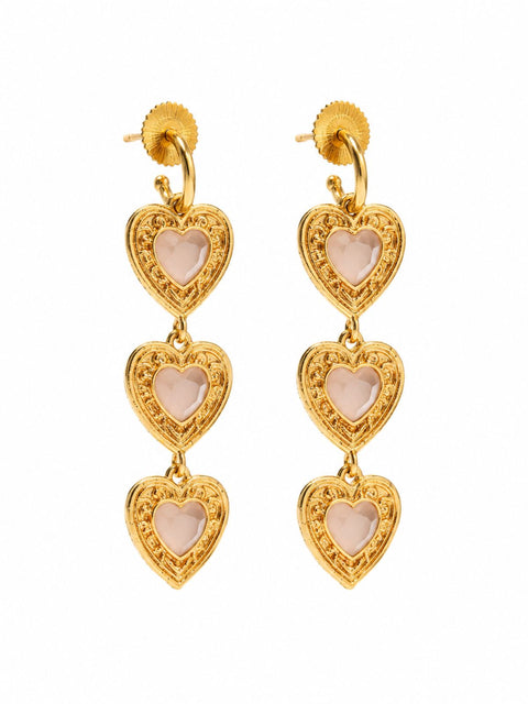 A pair of gold drop earrings featuring three stacked heart-shaped charms with pale pink centers