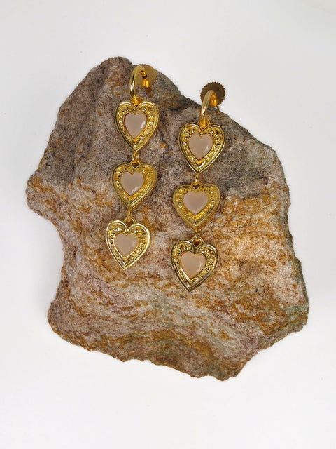 Triple heart gold drop earrings featuring soft milky heart stones