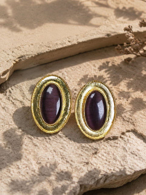 Close up of the Rhodes Earrings with polished Brown Cat Eye stones and textured gold detailing.