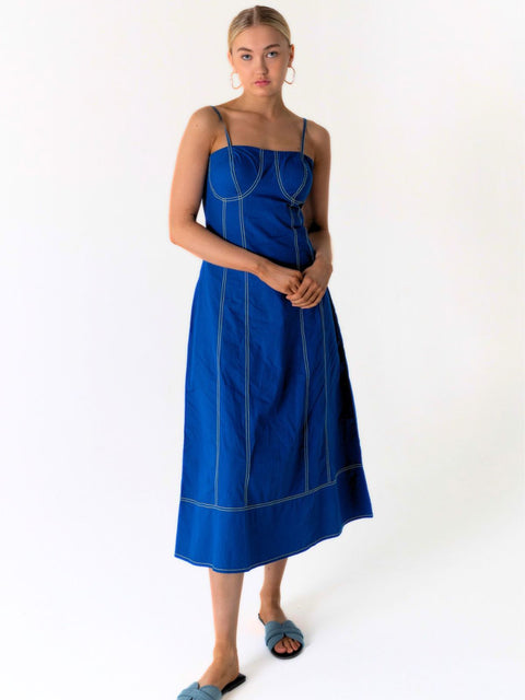 Summer Delight blue midi dress featuring a structured bodice, adjustable straps, yellow contrast stitching, side pockets and a full midi skirt