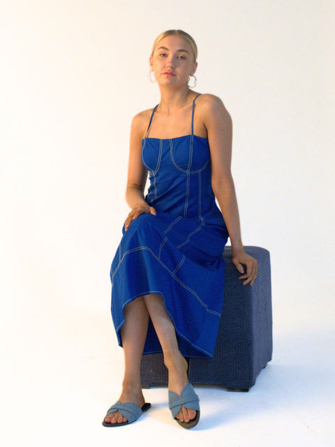 Cobalt blue cotton midi dress with decorative yellow contrast stitching and practical side pockets