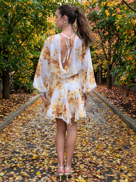 Harlow G amber spice floral mini dress with open back detail, tie neckline and flowing floral print fabric