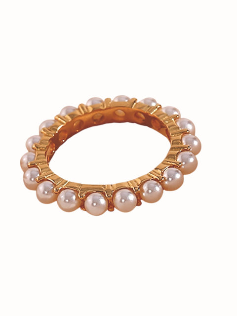 A gold-plated ring adorned with small, evenly spaced white faux pearls