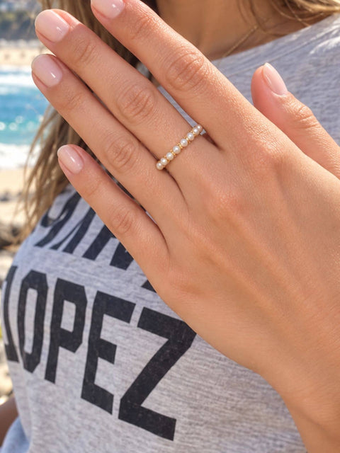 Delicate gold ring with a full halo of small white pearls for everyday wear