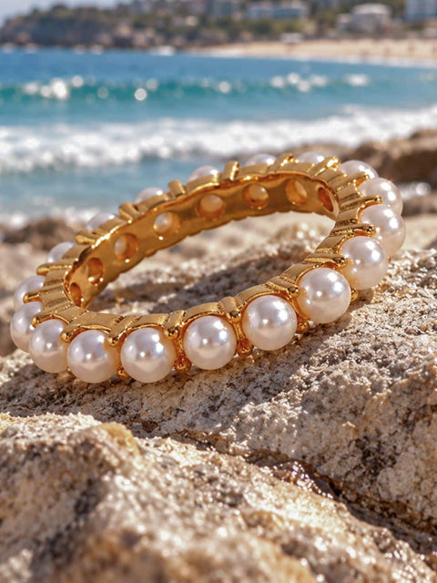 Gold tone pearl ring with dainty white pearls and a slim minimalist design