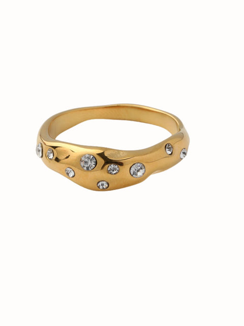 Mitra gold tone ring with a sculptural wavy band and scattered clear crystal accents