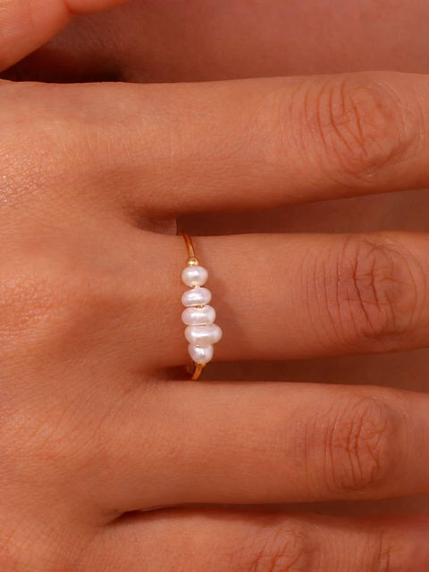 gold ring with a vertical cluster of five white freshwater pearls on a gold thin delicate band