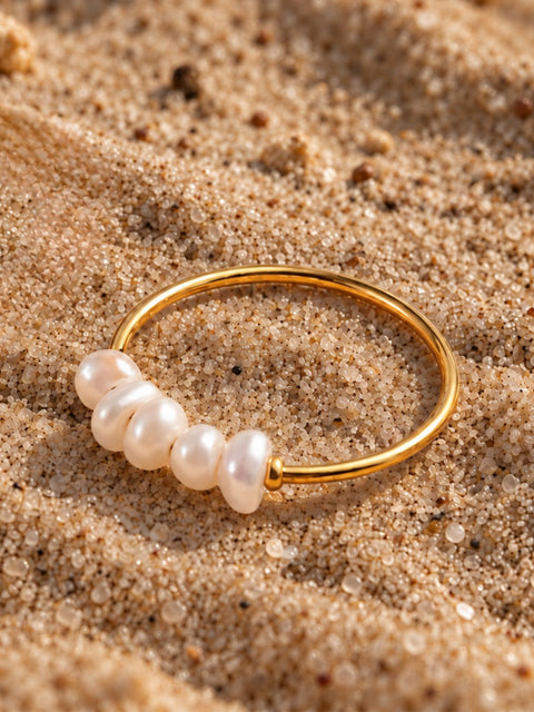 A gold  delicate band featuring five irregular white freshwater pearls